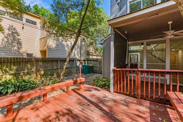 a view of a house with wooden floor next to a yard