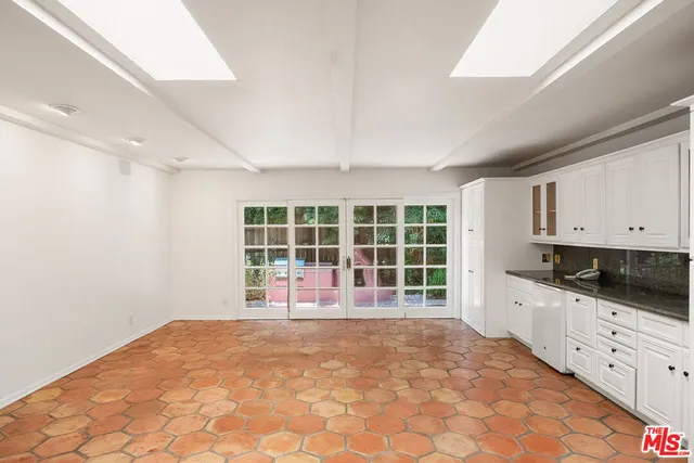 a view of a kitchen with a sink and dishwasher cabinets