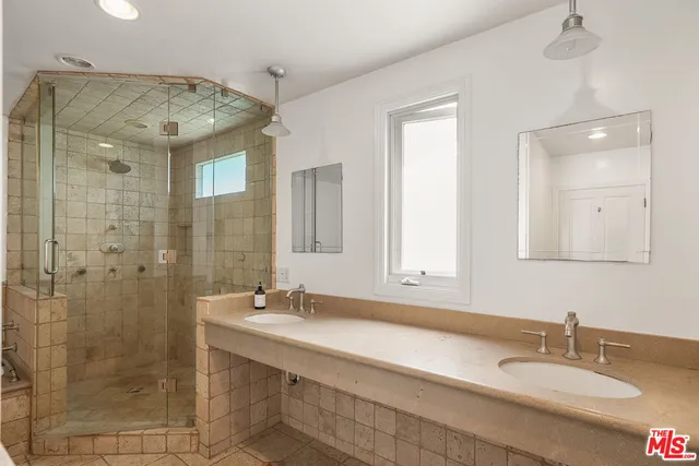 a bathroom with a sink double vanity and shower