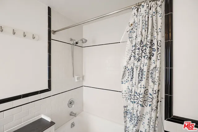 a bathroom with a shower and a shower curtain