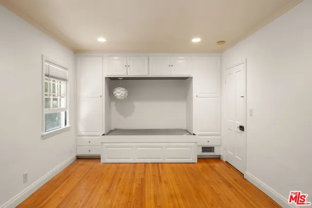 a view of room with window and wooden floor