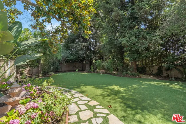 a view of a backyard with large trees