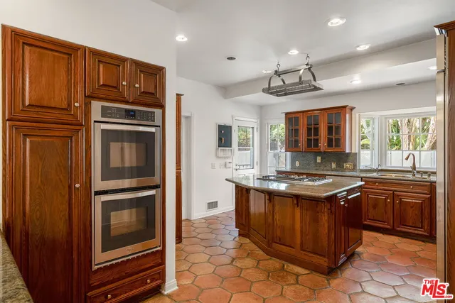 a kitchen with stainless steel appliances granite countertop a stove and a refrigerator