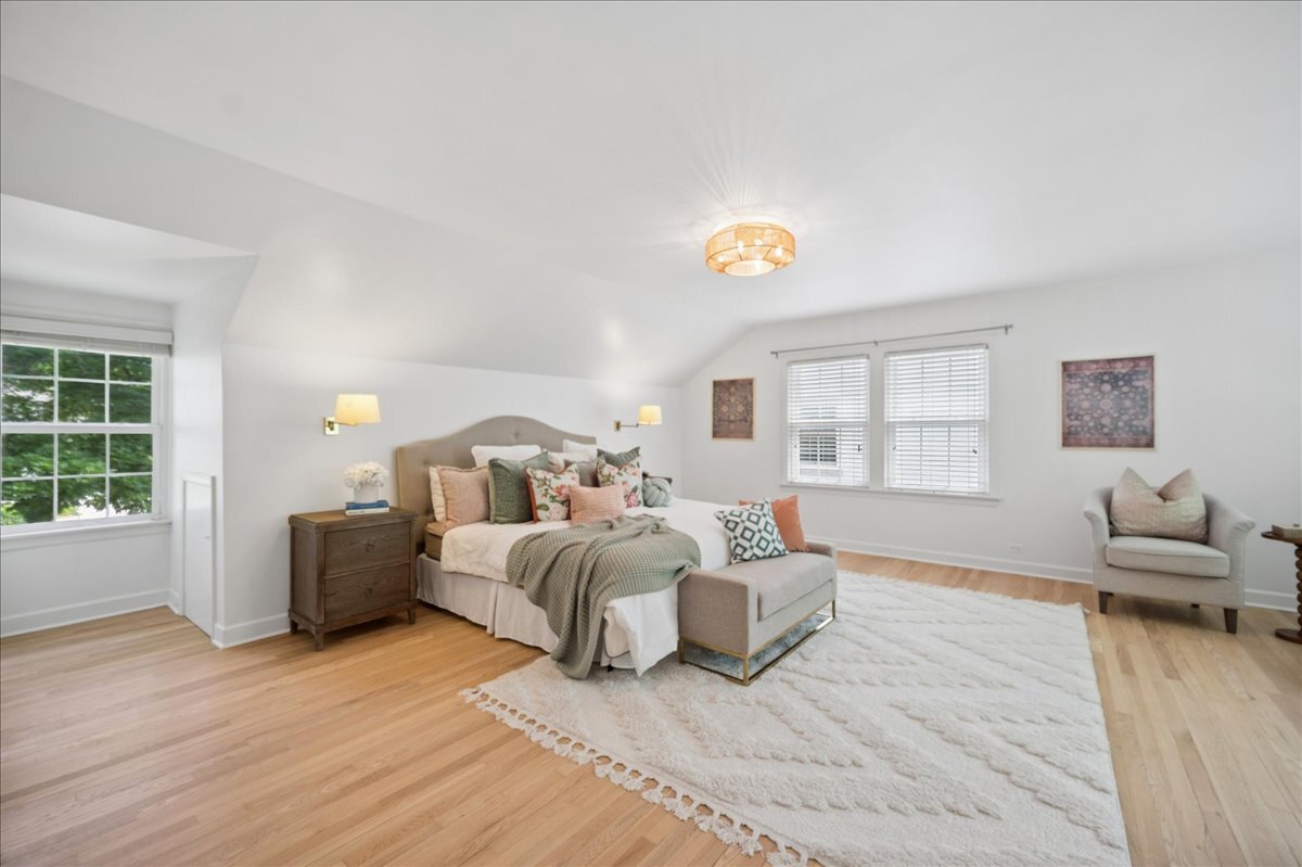 712 Juniper Road Glenview, IL 60025 - Photo 15 of 33 a spacious bedroom with a bed and wooden floor