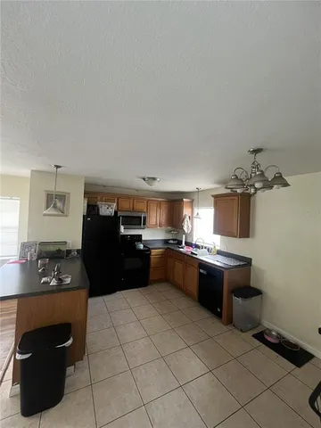 a kitchen with a stove and a refrigerator