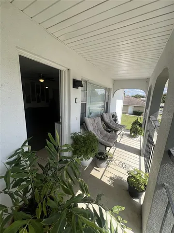 a room with furniture and a potted plant