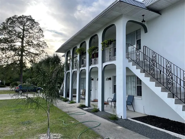 a view of a brick house with a yard