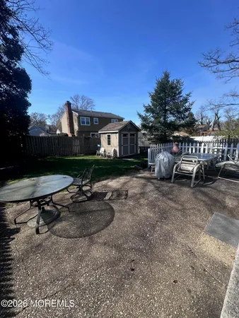 a view of a backyard with sitting area