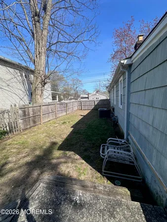 a view of a backyard with wooden fence