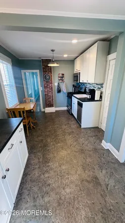a kitchen with a refrigerator and a sink