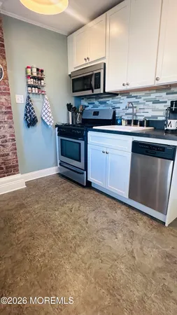 a kitchen with stainless steel appliances granite countertop a stove and a microwave