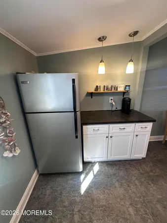 a kitchen with a sink and a refrigerator