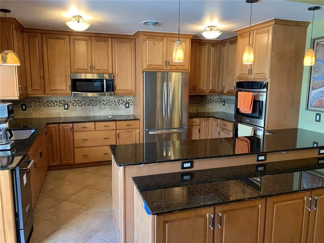 a living room with furniture a flat screen tv and a floor to ceiling window