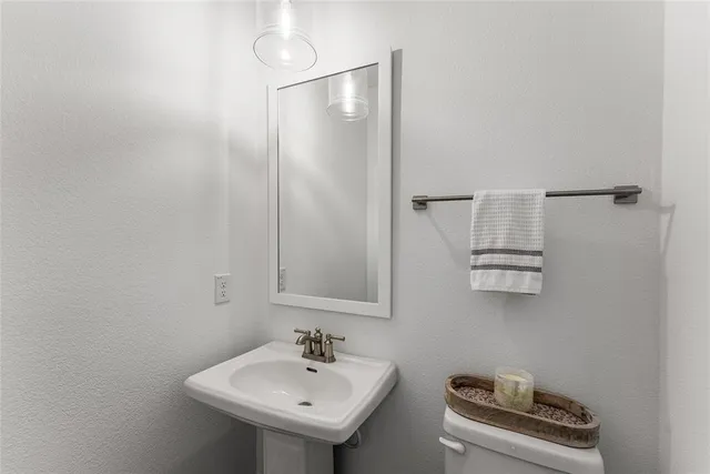 a bathroom with a sink a mirror and shower curtain