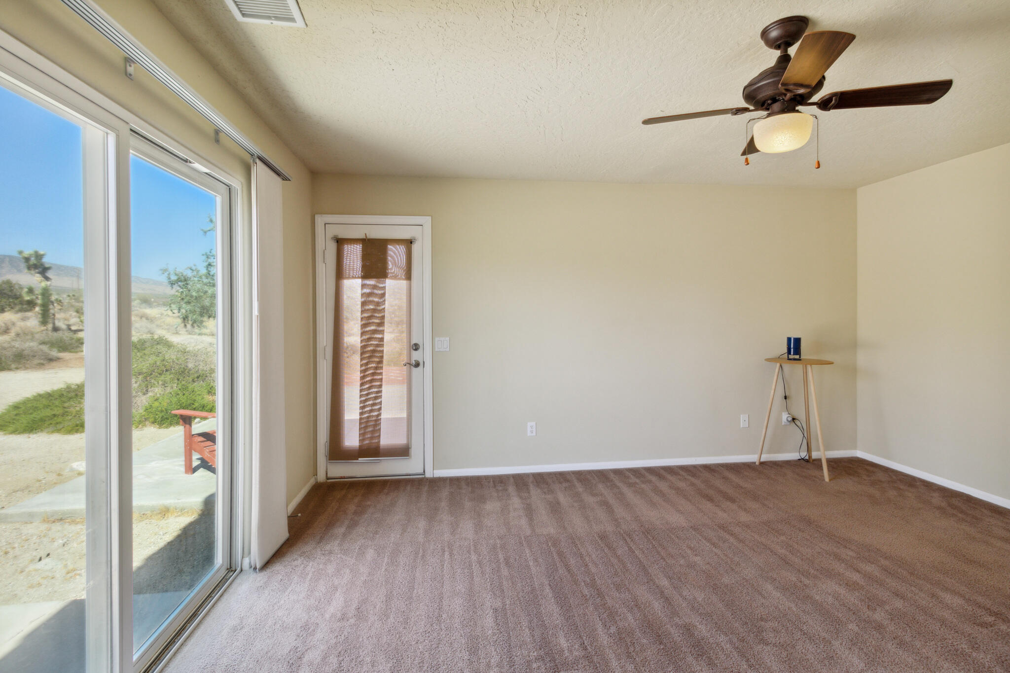 381 Calaveras Road Pinon Hills, CA 92372 - Photo 16 of 27 a view of empty room with wooden floor and fan
