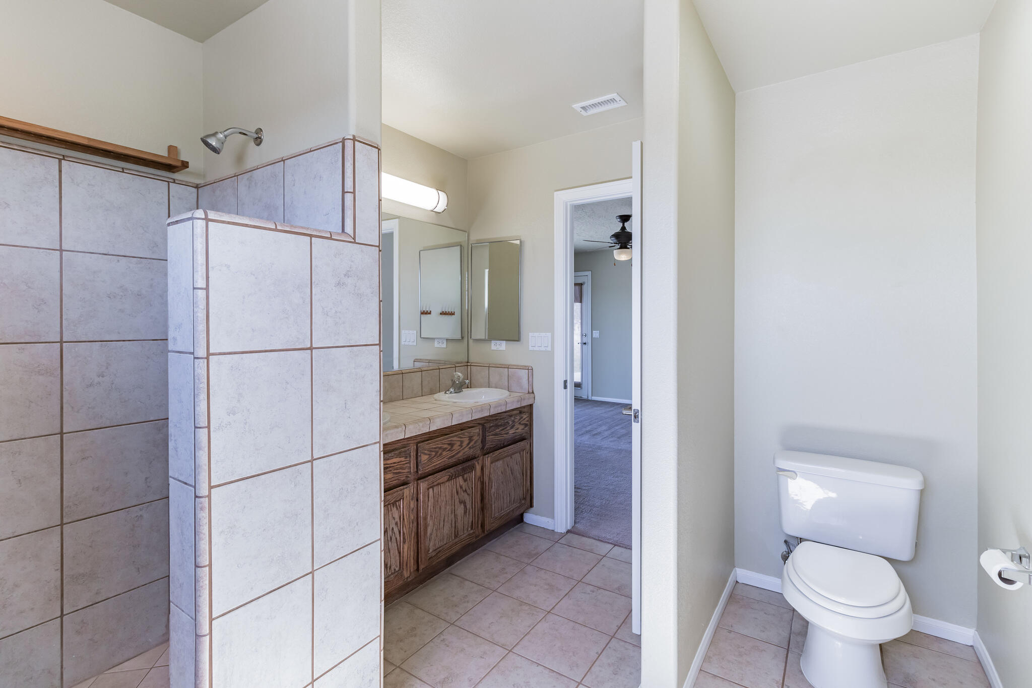 381 Calaveras Road Pinon Hills, CA 92372 - Photo 19 of 27 a bathroom with a granite countertop sink mirror vanity and toilet