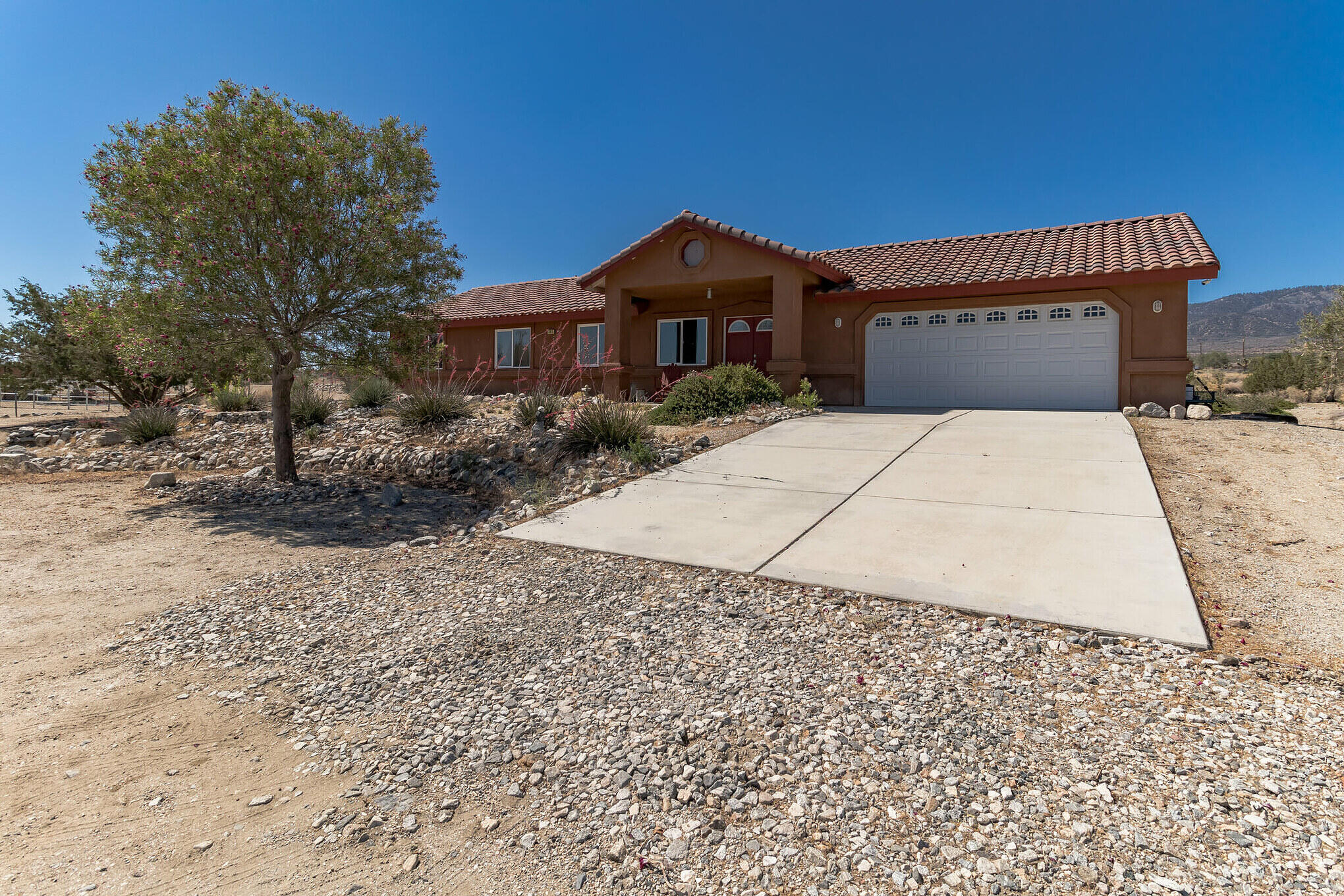 381 Calaveras Road Pinon Hills, CA 92372 - Photo 2 of 27 a front view of a house with a yard