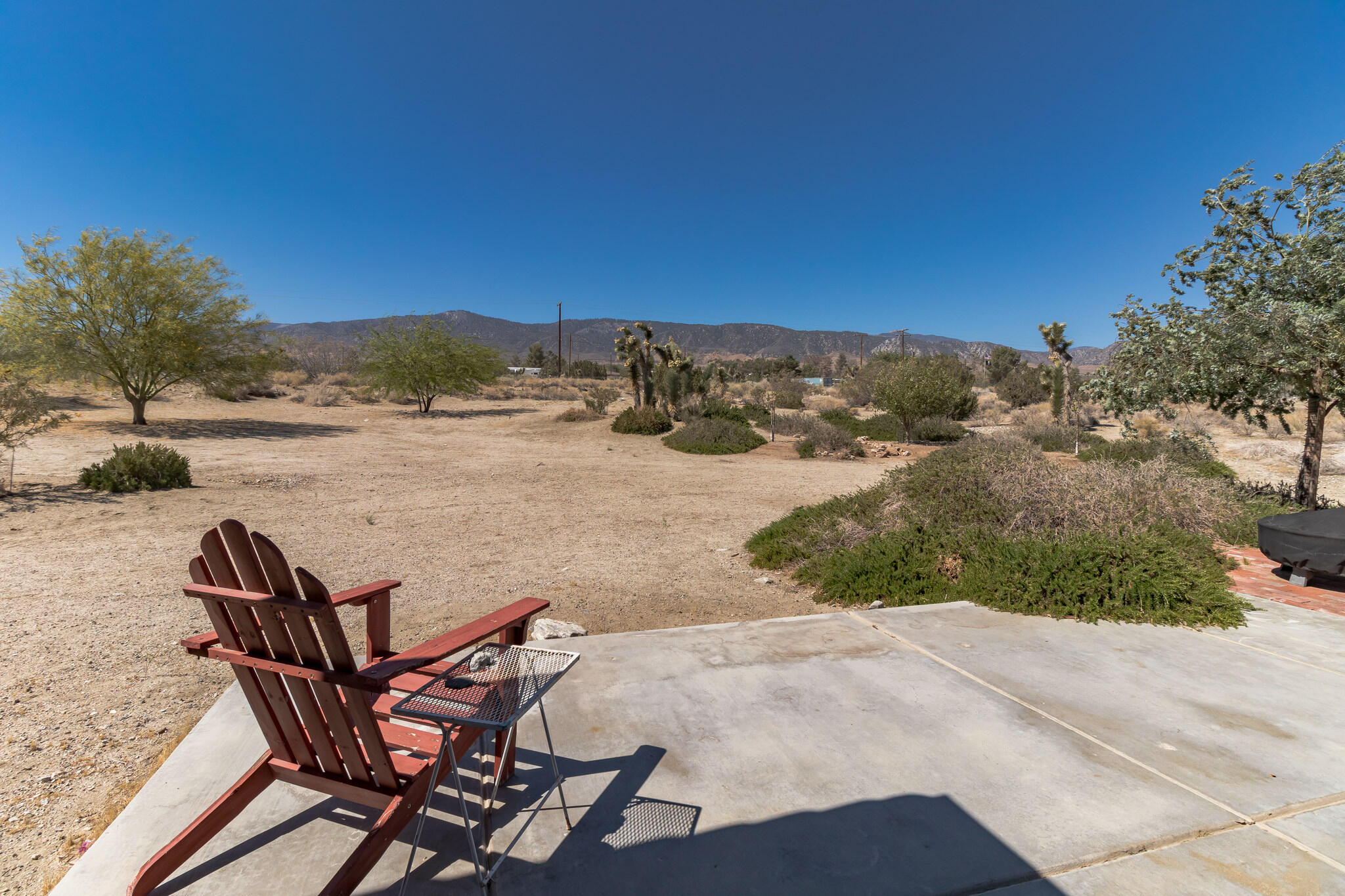 381 Calaveras Road Pinon Hills, CA 92372 - Photo 26 of 27 a view of a terrace with chair and trees
