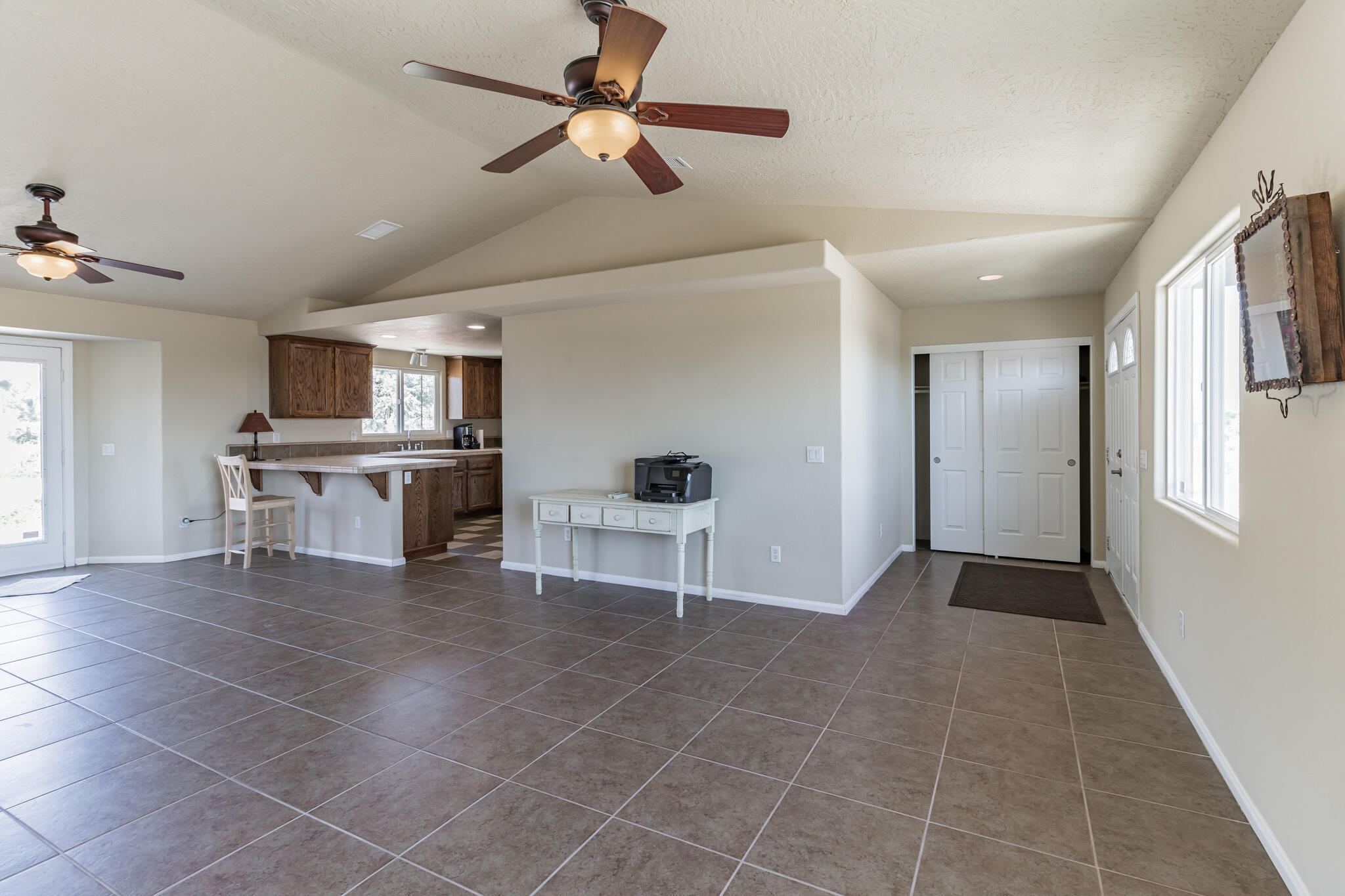 381 Calaveras Road Pinon Hills, CA 92372 - Photo 3 of 27 a view of a livingroom with furniture a ceiling fan and window