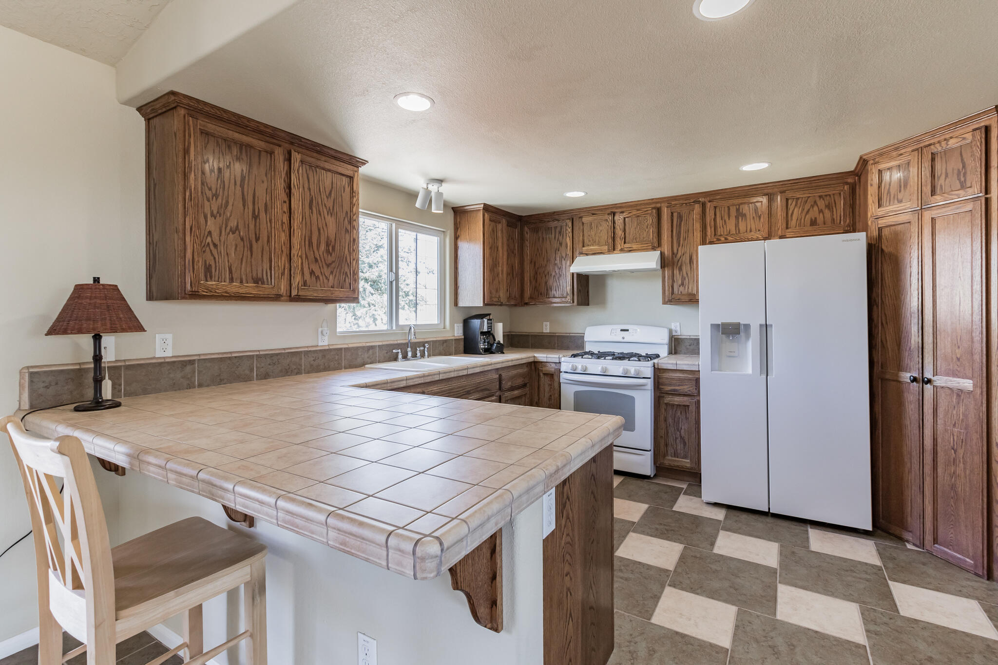 381 Calaveras Road Pinon Hills, CA 92372 - Photo 5 of 27 a kitchen with a stove a sink and a refrigerator