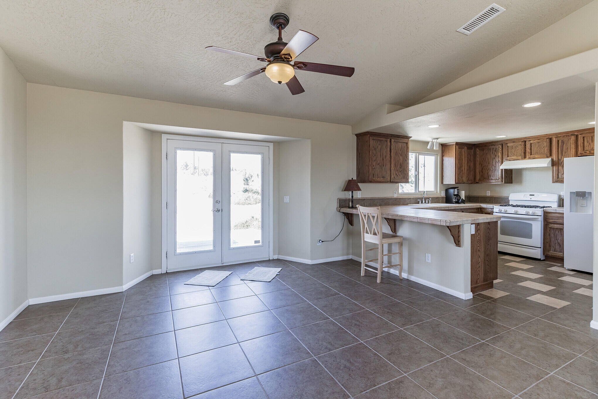 381 Calaveras Road Pinon Hills, CA 92372 - Photo 8 of 27 a kitchen with stainless steel appliances granite countertop a stove top oven a sink a counter top space cabinets and a window
