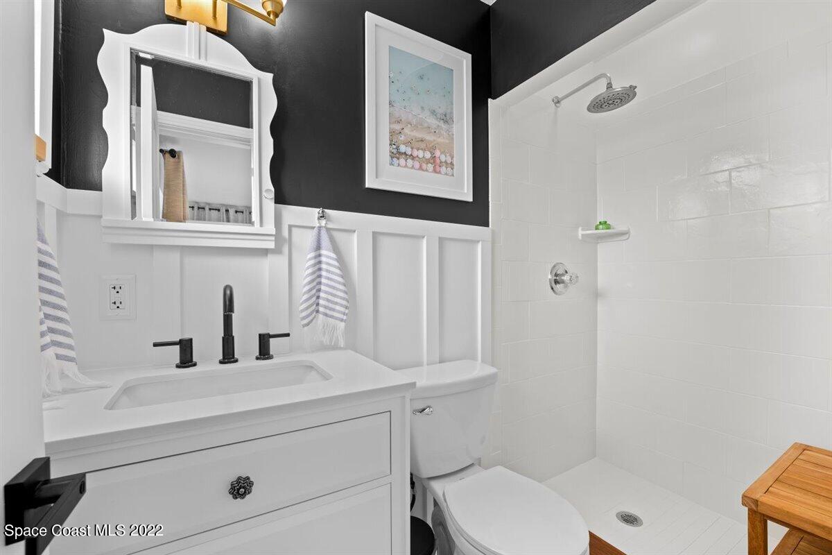 623 Bermuda Road Cocoa Beach, FL 32931 - Photo 20 of 29 a bathroom with a toilet sink and mirror
