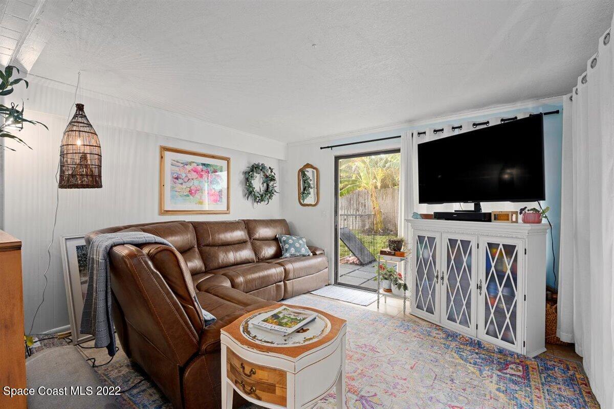 623 Bermuda Road Cocoa Beach, FL 32931 - Photo 7 of 29 a living room with furniture and a flat screen tv
