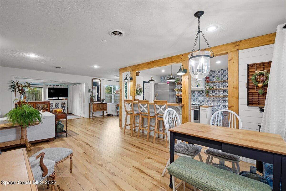 623 Bermuda Road Cocoa Beach, FL 32931 - Photo 8 of 29 a living room with furniture ceiling fan and a wooden floor