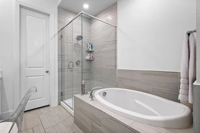 a bathroom with a bathtub and a shower