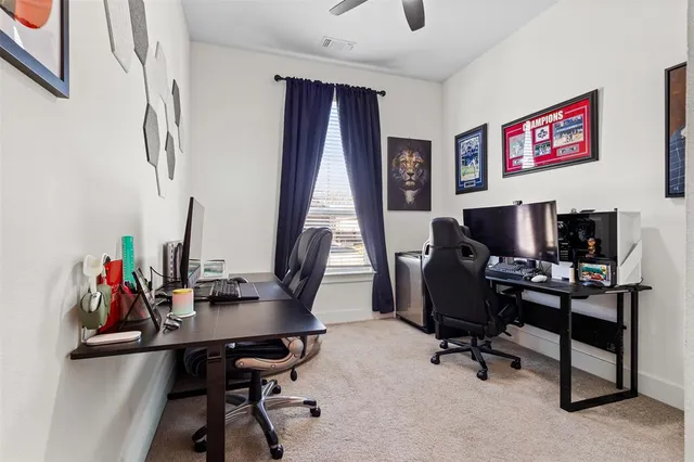 a view of a workspace with furniture and a window