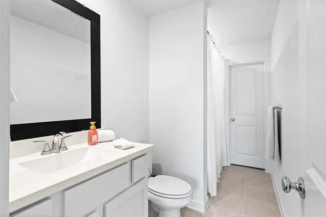 a bathroom with a sink toilet and vanity