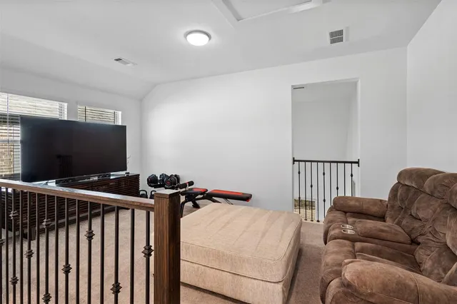 a projector room with furniture and a flat screen tv