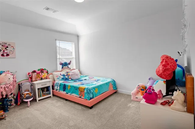 a bedroom with two beds and a window