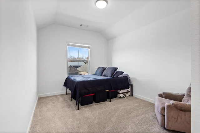 a bedroom with bed and a couch