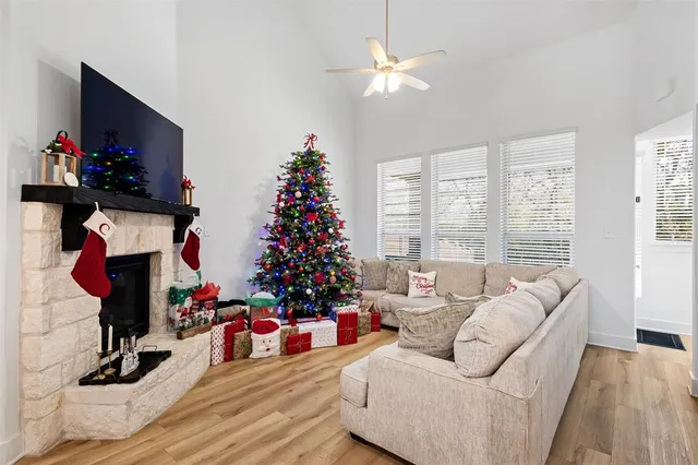 a living room with furniture a flat screen tv and a large window