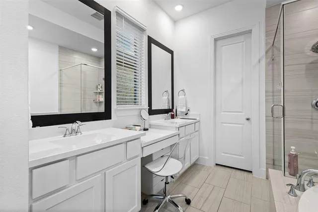 a bathroom with a double vanity sink mirror and double