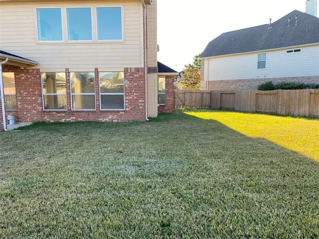 a front view of a house with yard and green space