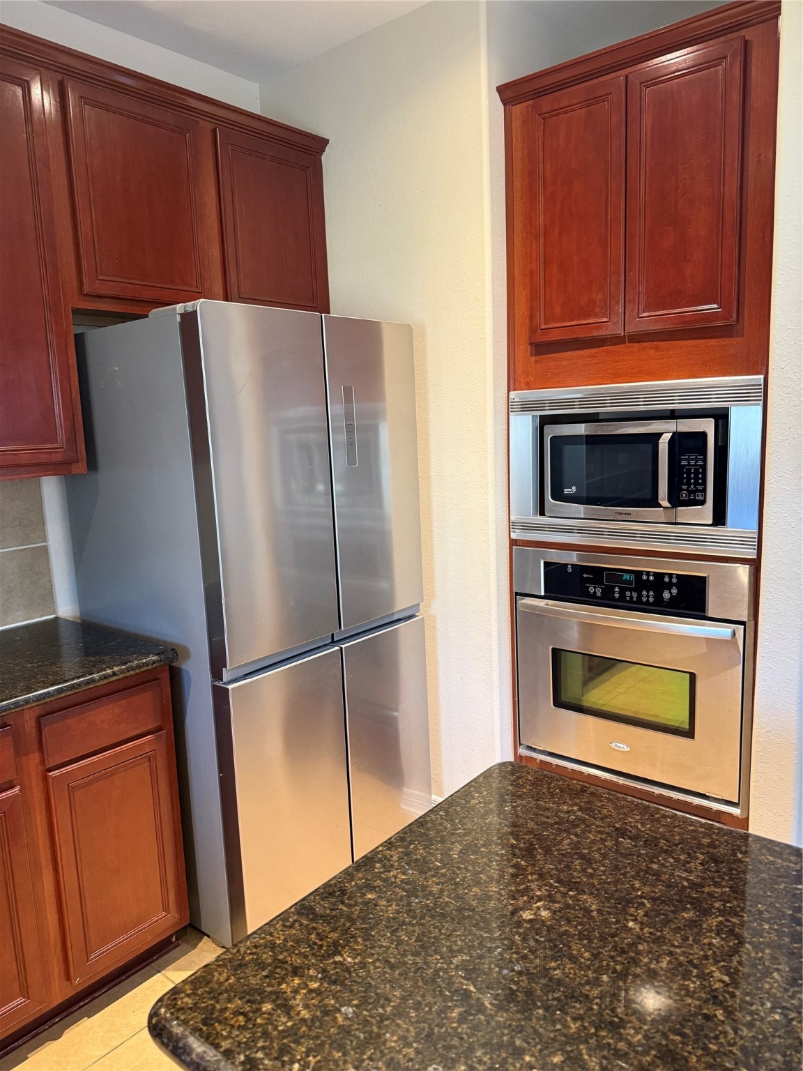 10930 Reston Point Drive Richmond, TX 77406 - Photo 6 of 26 a kitchen with a refrigerator and a stove top oven