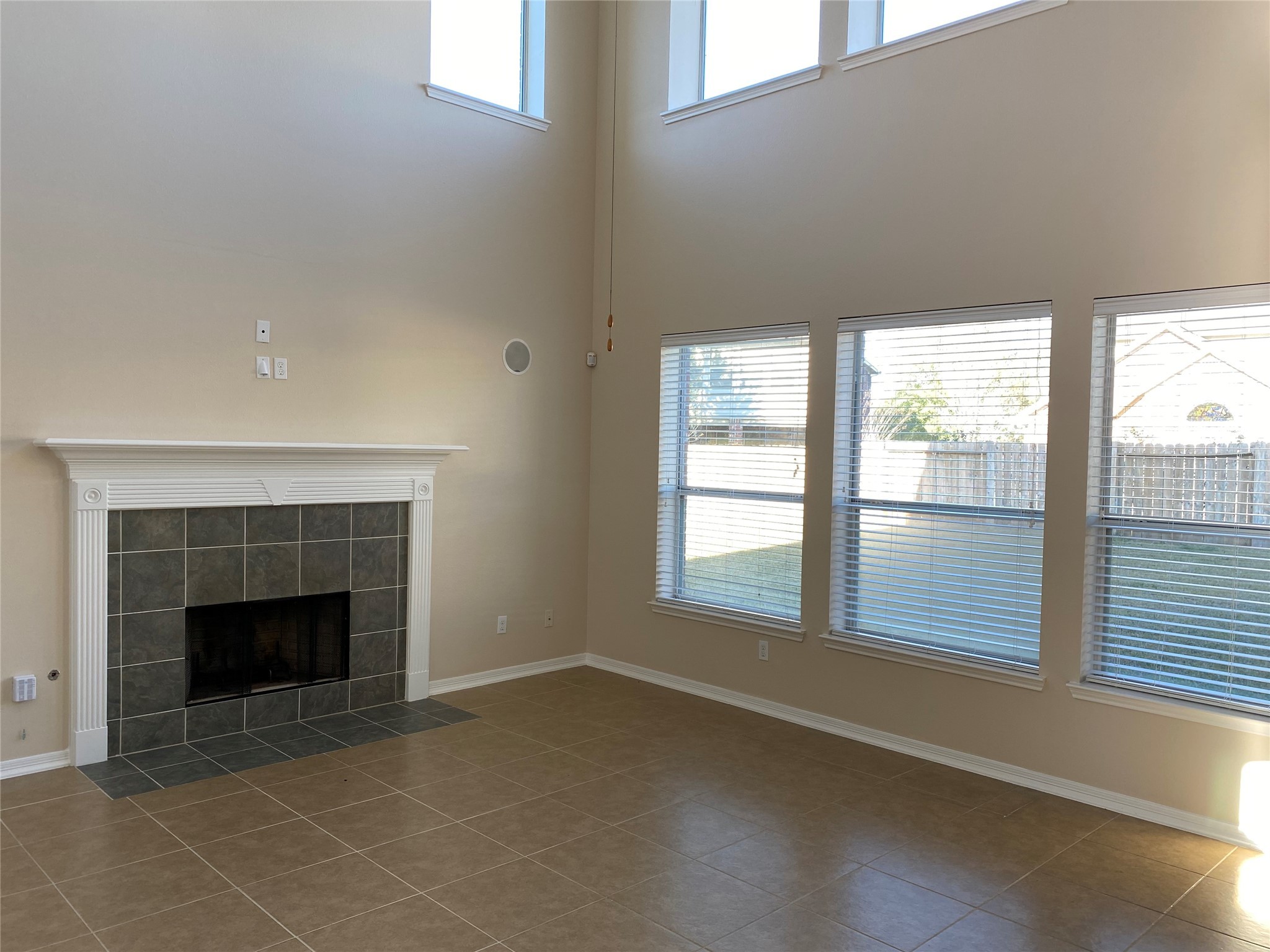 10930 Reston Point Drive Richmond, TX 77406 - Photo 8 of 26 an empty room with windows and fireplace