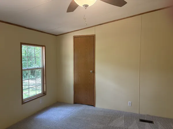 an empty room with windows and closet