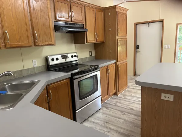 a kitchen with stainless steel appliances granite countertop a sink and a stove