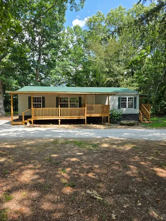 a view of a house with backyard and a patio