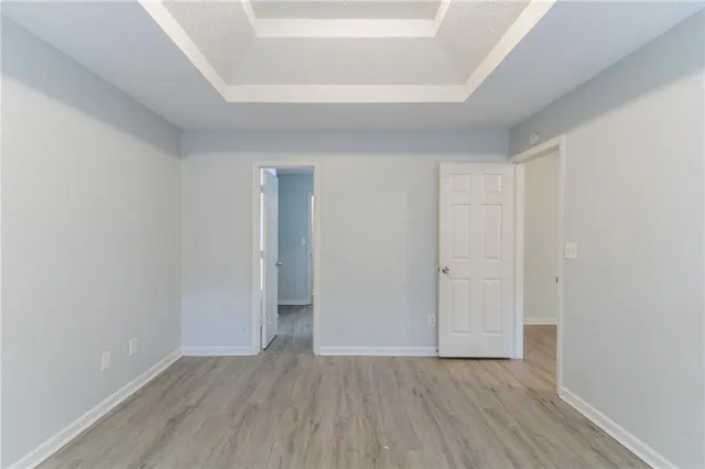 a view of an empty room and wooden floor