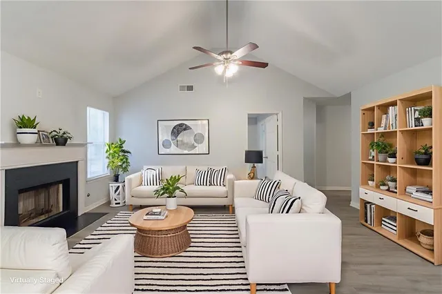 a living room with furniture and a fireplace