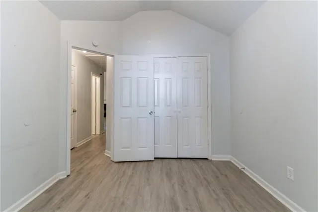 an empty room with wooden floor