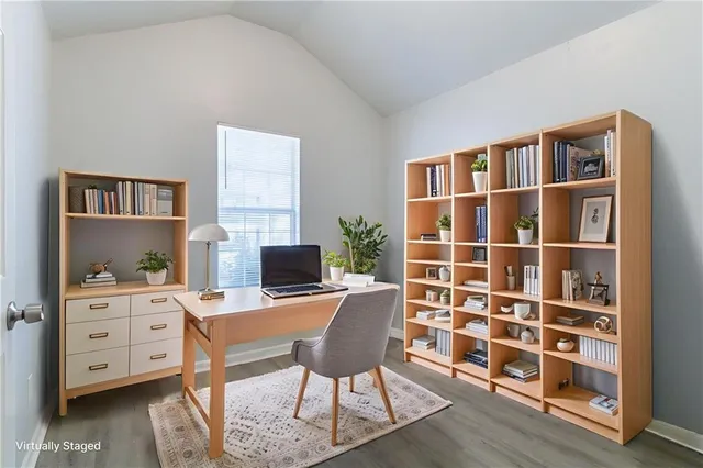 a view of a workspace with furniture and a flat screen tv