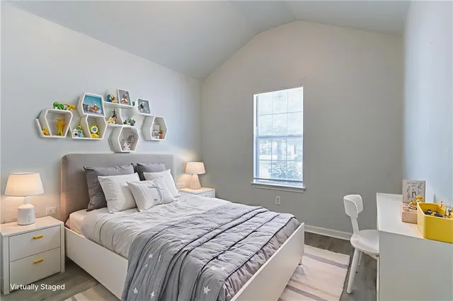 a bedroom with a bed and painting on the wall