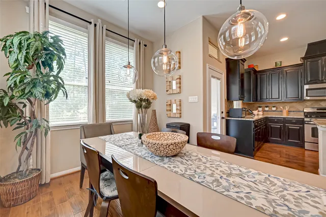 a kitchen with granite countertop a table and chairs in it