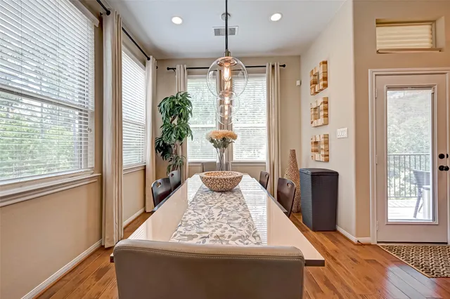 a kitchen with granite countertop a stove cabinets and chairs