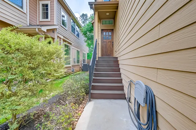 a view of a pathway of a house with wooden walls and stairs